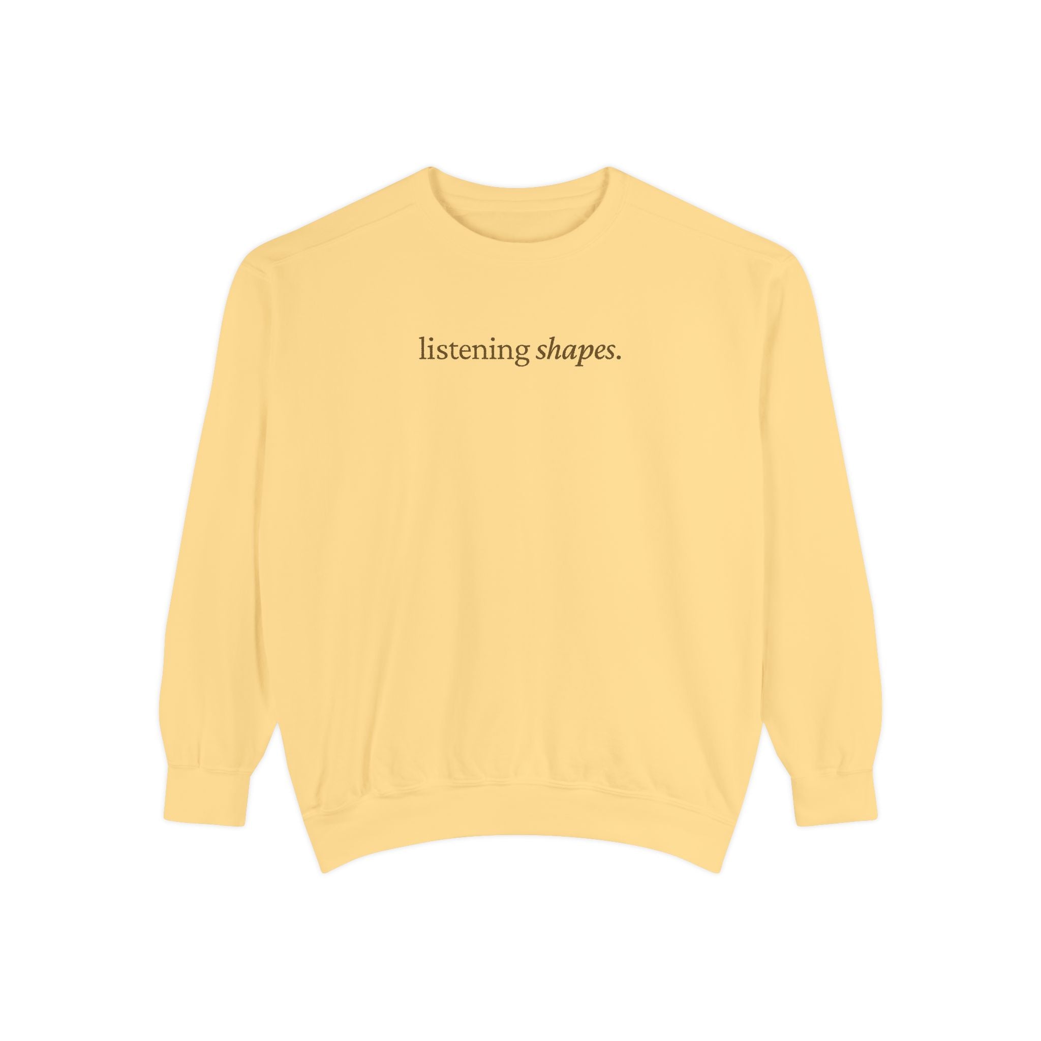 Yellow sweatshirt with 'listening shapes' text on a white background