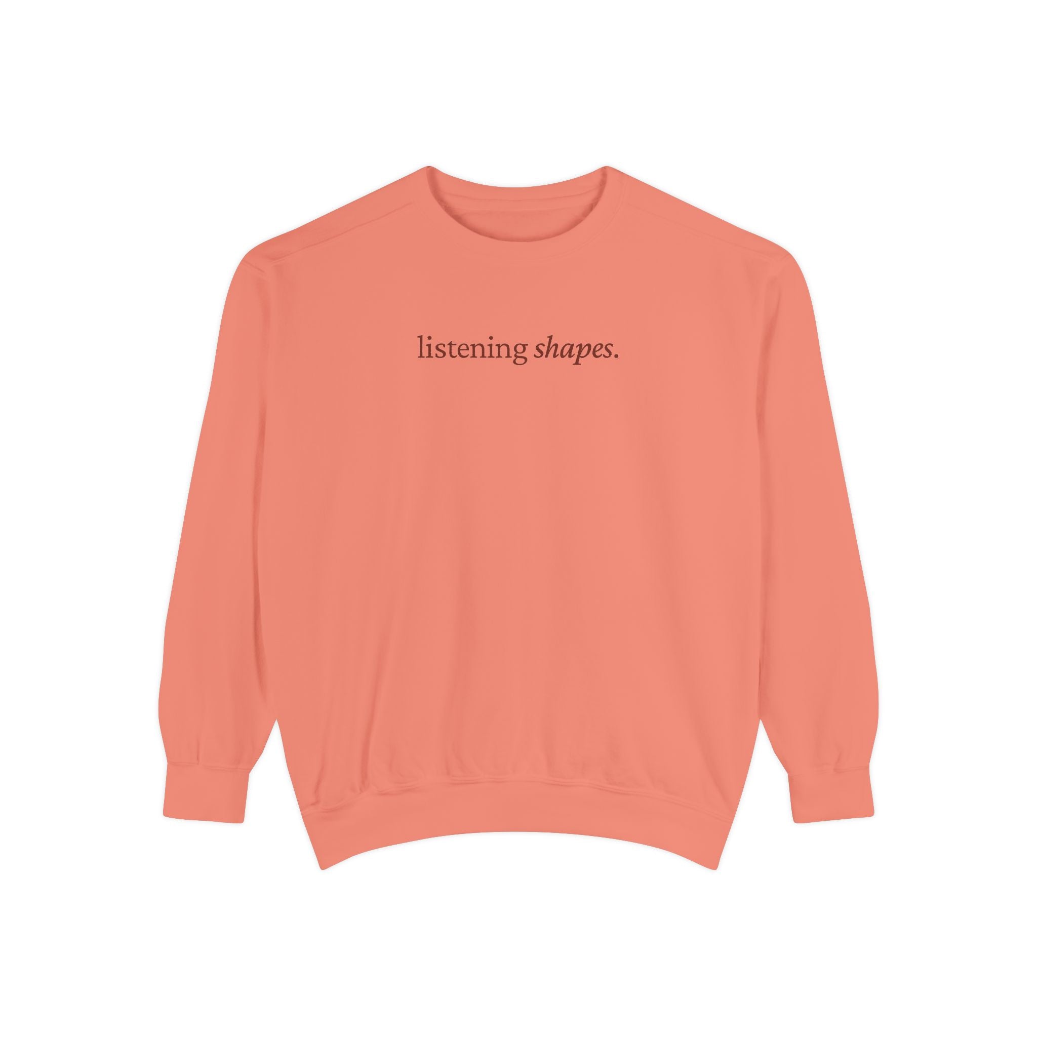 Coral sweatshirt with 'listening shapes' text on a white background